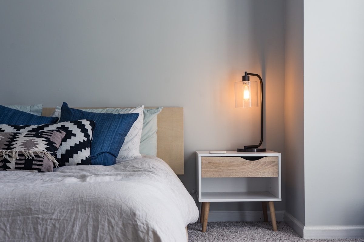 A made-up spare bedroom with natural light