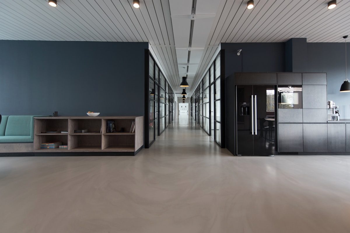 A bright office interior with long tables and large windows