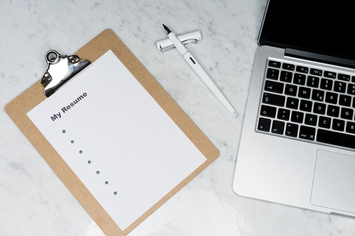 Open notebook with a pen on a wooden desk